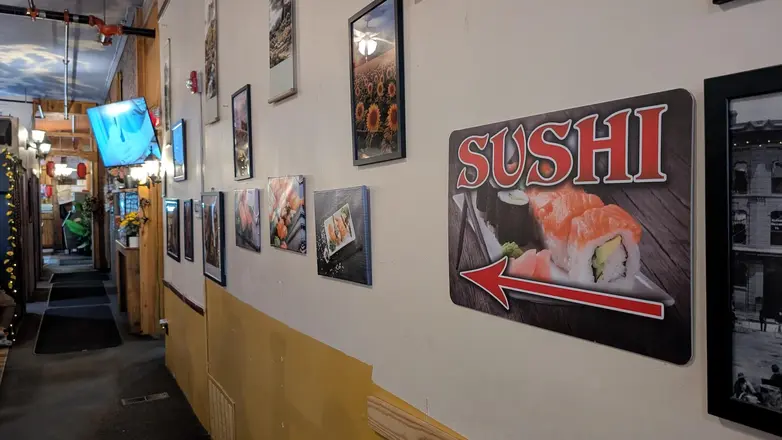 The hallway, hung with framed photographs