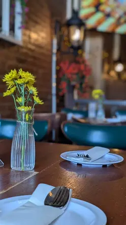 Yellow flowers on a table set by the window