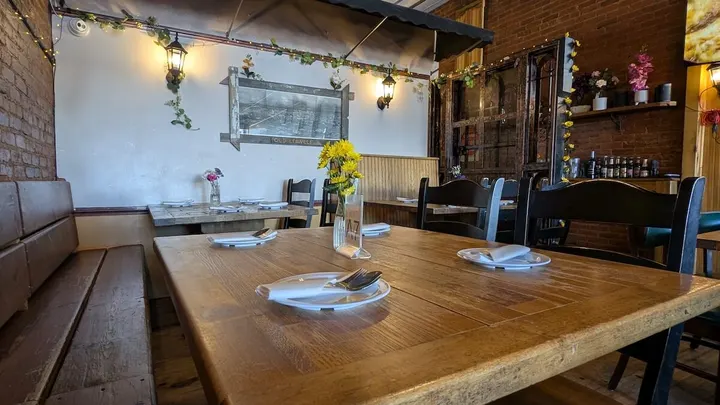 A wooden table beside the banquette