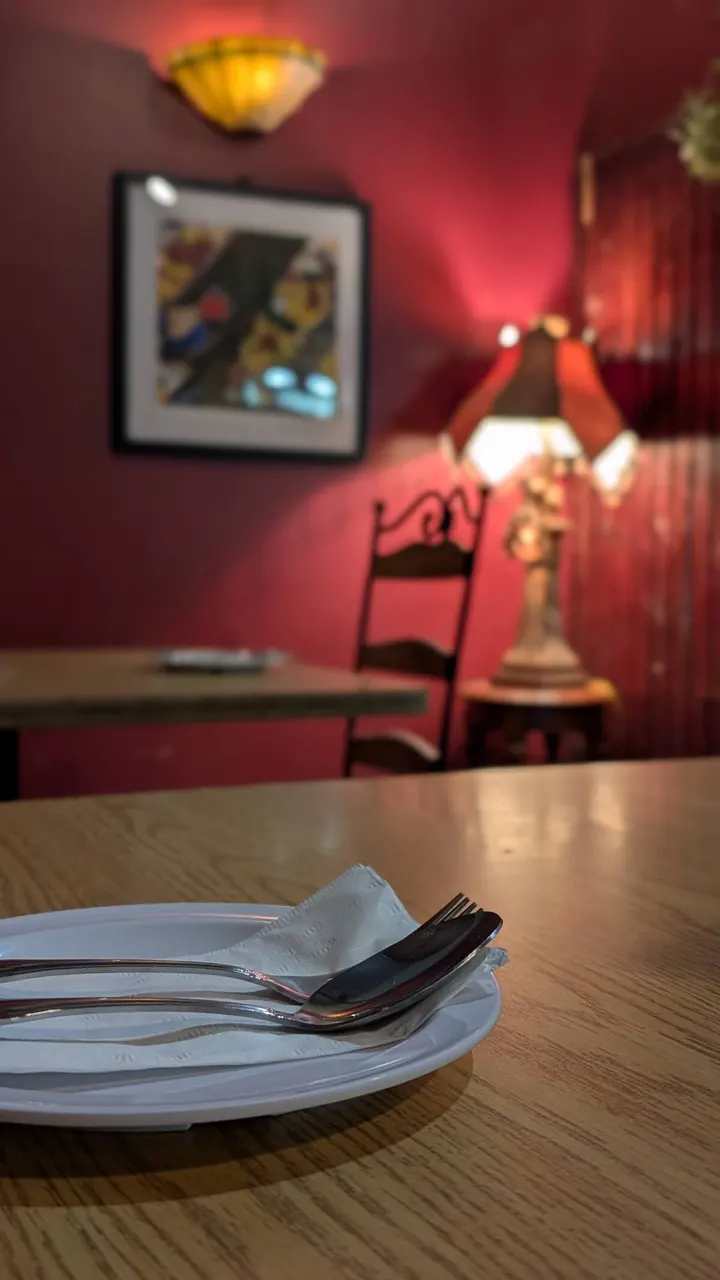 A set table in the red-walled corner