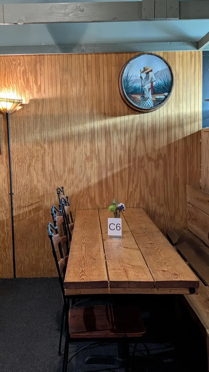 A long table in the wood-paneled side room