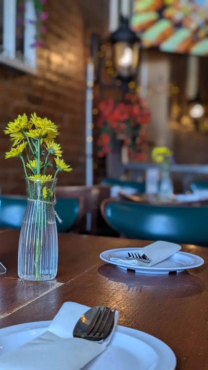 Yellow flowers on a table set by the window