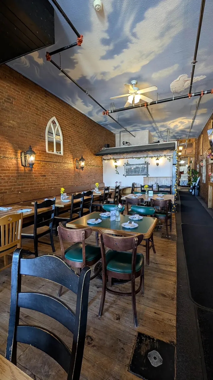 Rows of tables under the painted-sky ceiling